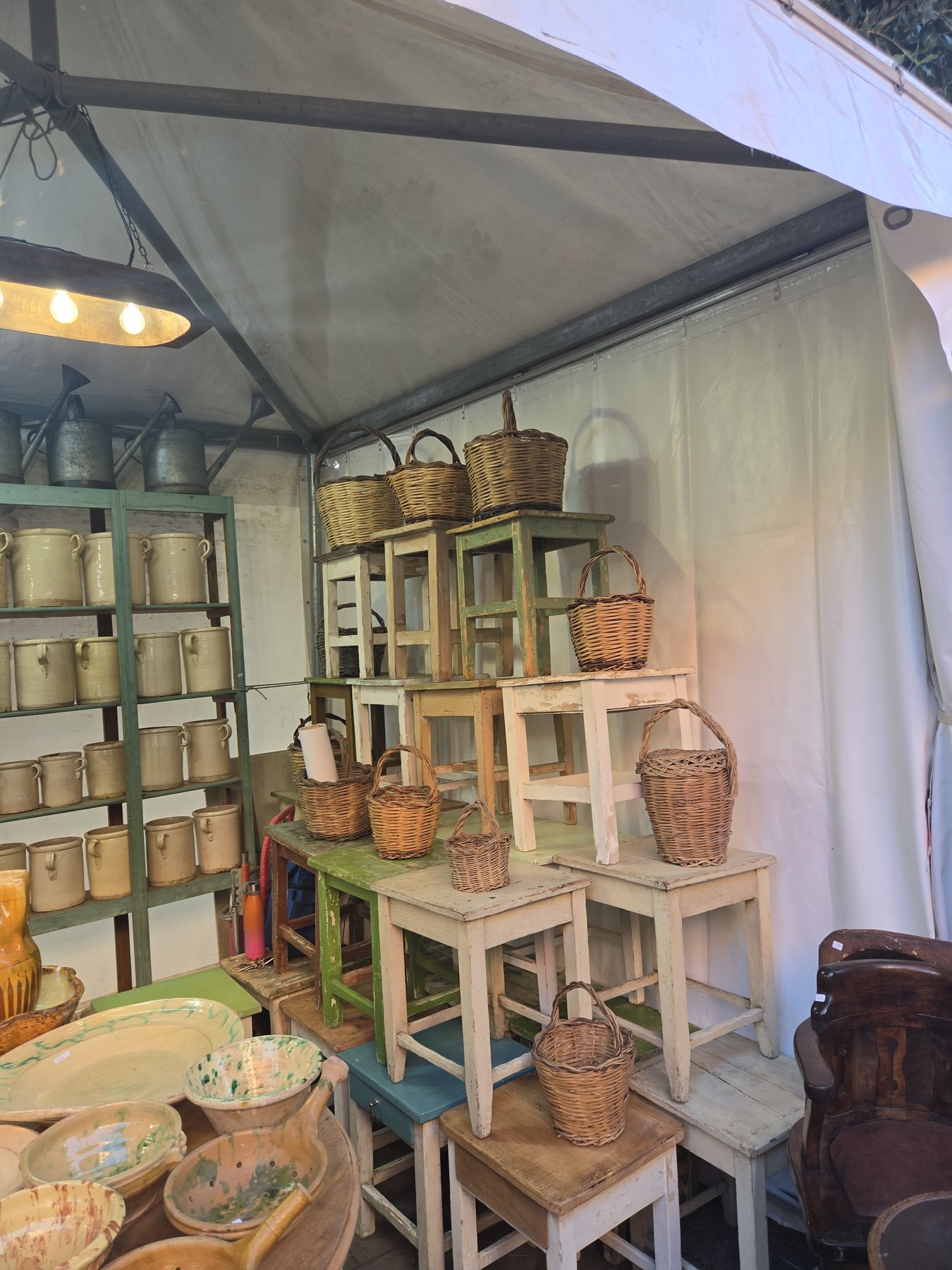 A Pugliese brocante under string lights — where Casa Andrea's curated furniture is found, Puglia